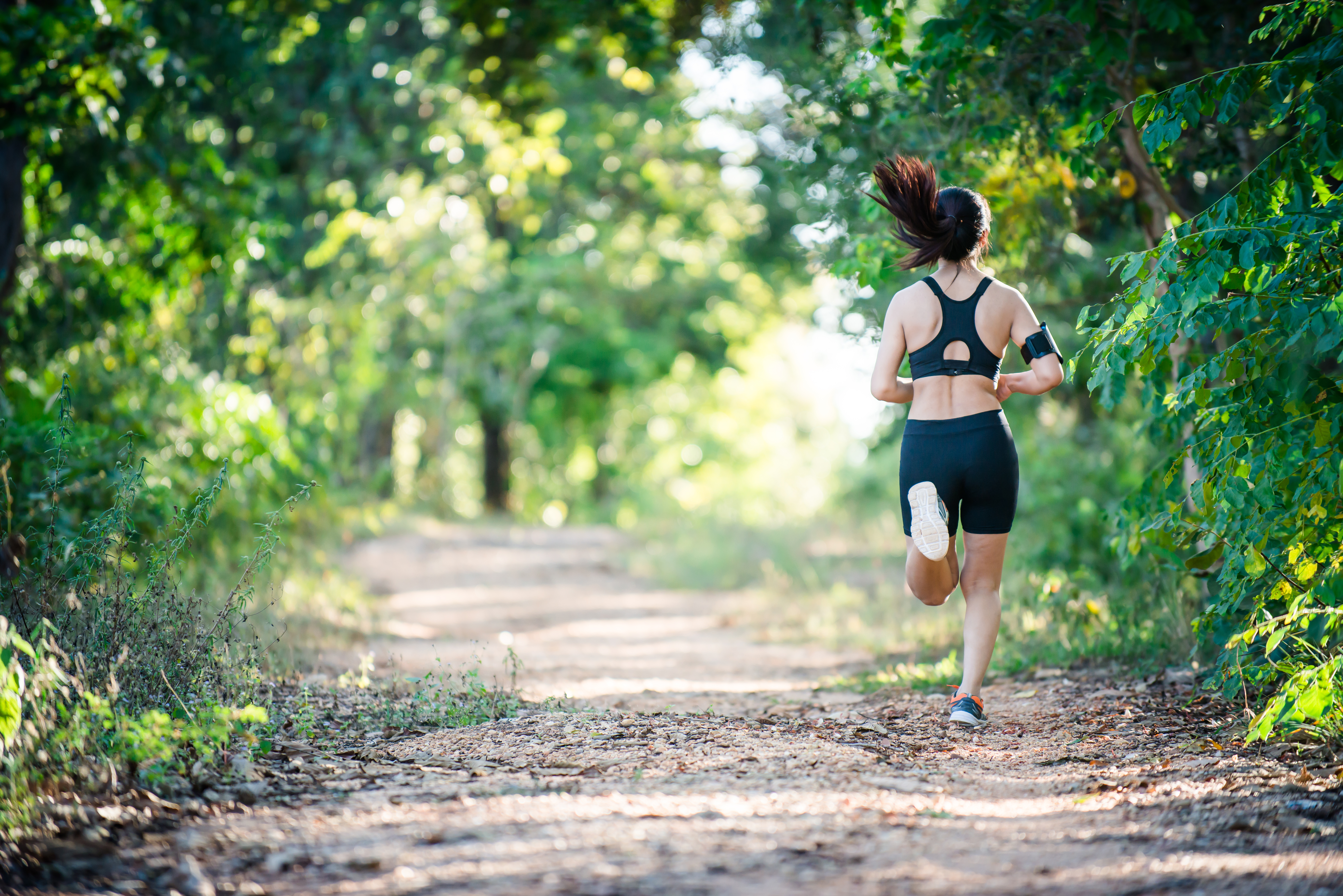 Young fitness woman running on a rural road. Sport woman running,Healthy lifestyle concept.